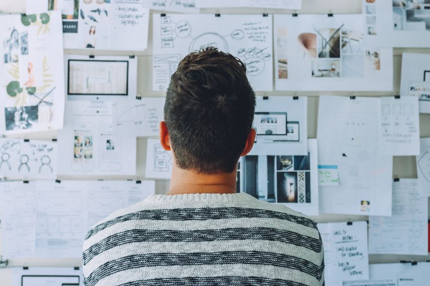 Man looking at papers to create customer work flow