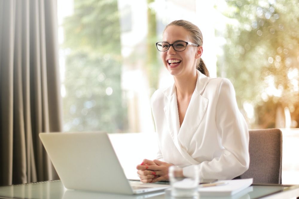 Lady employee smiling while on the computer